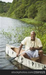Mature man canoeing in a lake