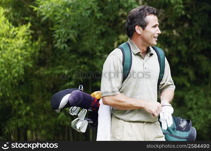 Mature man carrying a golf bag