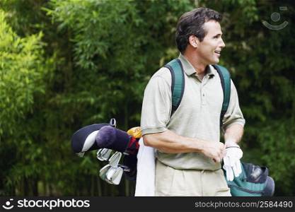 Mature man carrying a golf bag