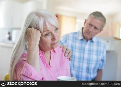 Mature Man Comforting Woman With Depression At Home