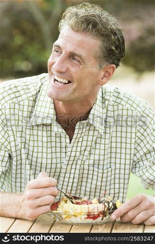 Mature man eating an ice cream and smiling