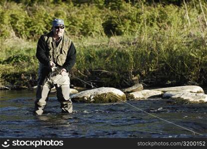 Mature man fishing in the river