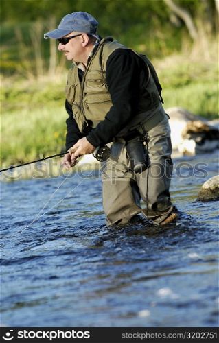 Mature man fishing in the river
