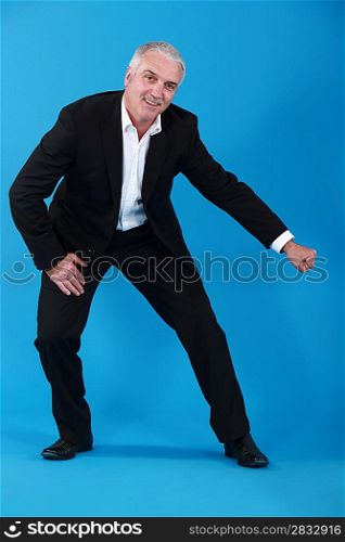 Mature man gesturing on blue background