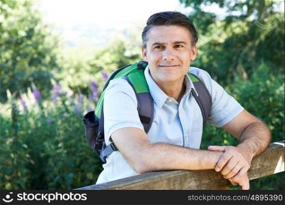 Mature Man Hiking In Countryside