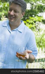Mature man holding a glass of wine