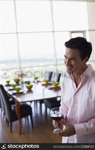 Mature man holding a glass of wine