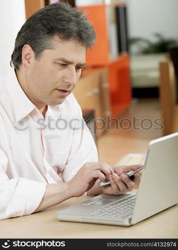 Mature man holding a mobile phone