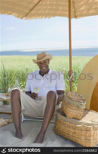 Mature man holding a wine glass and smiling