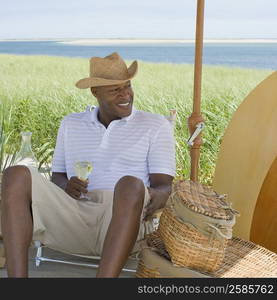 Mature man holding a wine glass and smiling