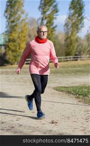 Mature man jogging in by lake in morning time ,feeling young again
