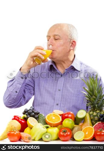 mature man juice and standing next to fruits and vegetables isolated on white. mature man juice