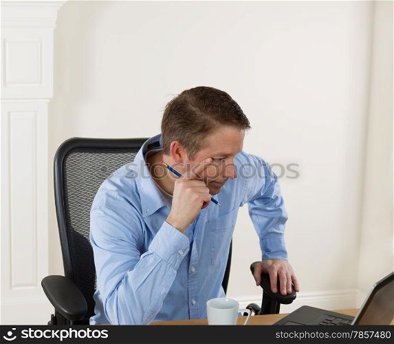 Mature man looking at computer screen while working