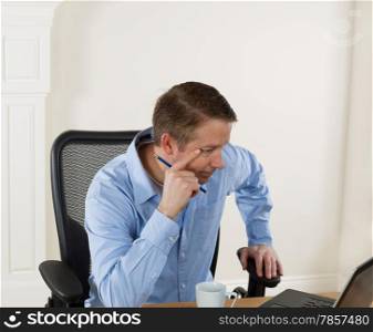 Mature man looking at computer screen while working