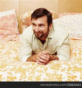 Mature man lying on the bed and smiling