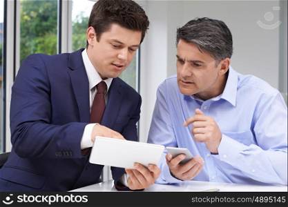 Mature Man Meeting With Financial Advisor At Home