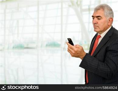 mature man on the phone at the office