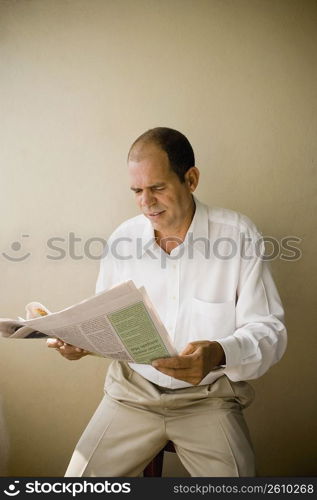 Mature man reading a newspaper