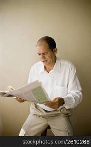 Mature man reading a newspaper