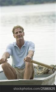 Mature man rowing a boat