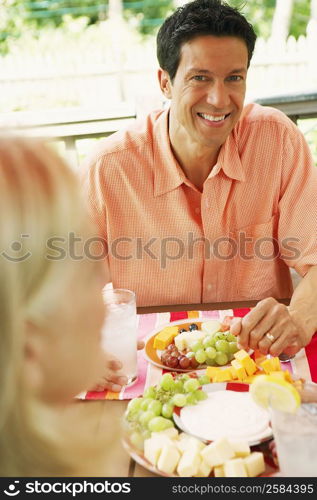 Mature man sitting at a table with a woman in front of him