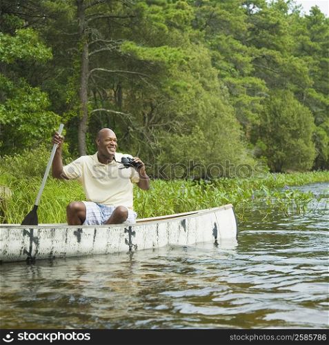Mature man sitting in a canoe and smiling