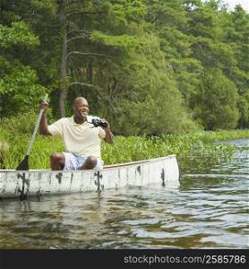 Mature man sitting in a canoe and smiling