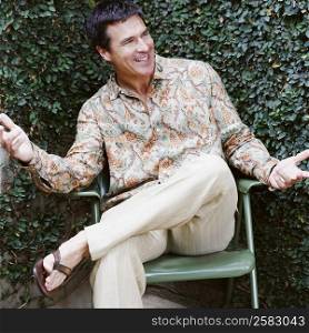 Mature man sitting on a chair and smiling