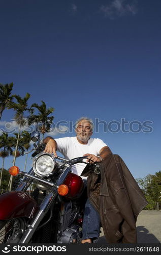 Mature man sitting on a motorcycle