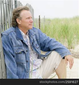Mature man sitting on the beach