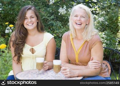 Mature man sitting with her daughter and holding cold coffee cups