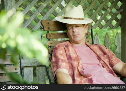 Mature man sleeping on a chair