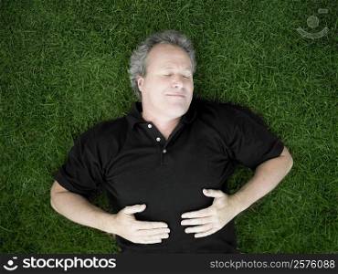 Mature man sleeping on the grass