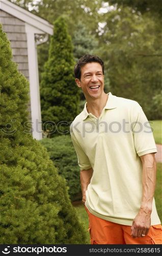 Mature man smiling and standing in a park