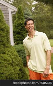 Mature man smiling and standing in a park