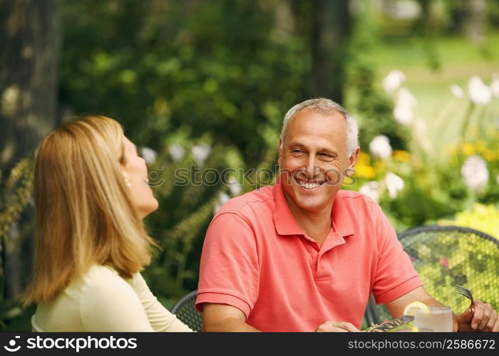 Mature man smiling with a mid adult woman