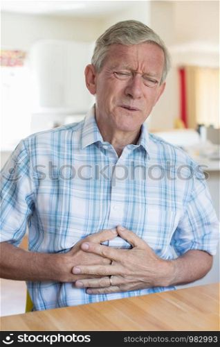 Mature Man Suffering From Stomach Pain At Home