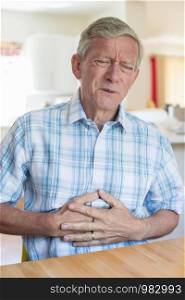Mature Man Suffering From Stomach Pain At Home