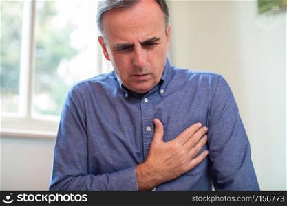 Mature Man Suffering Heart Attack And Chest Pains At Home
