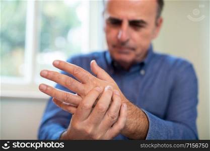 Mature Man Suffering With Repetitive Strain Injury