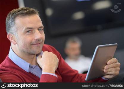 mature man using a tablet