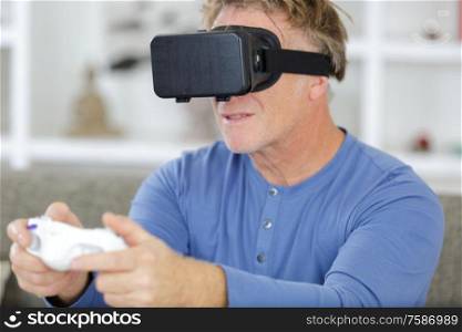 mature man wearing virtual reality glasses