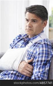 Mature Man With Arm In Sling At Home
