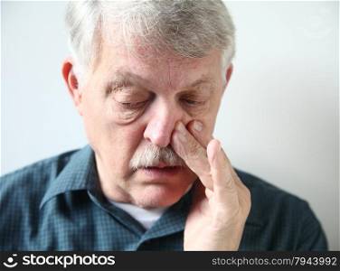 mature man with congestion from a cold or allergies