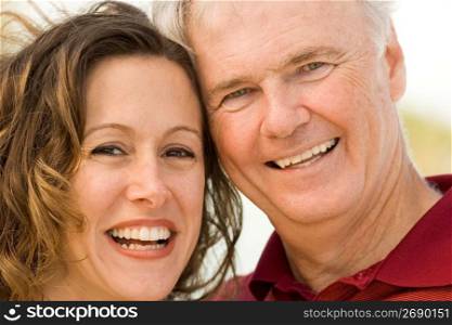 Mature man with mid adult woman smiling, close-up