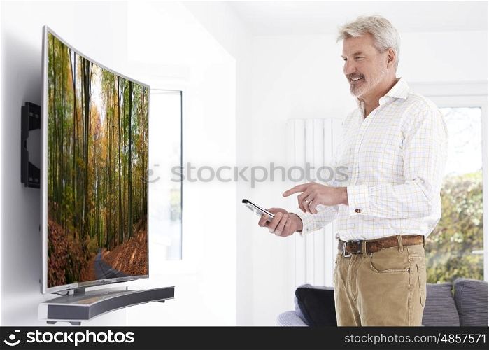 Mature Man With New Curved Screen Television At Home
