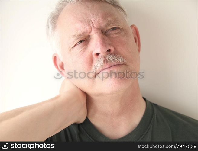 mature man with soreness in his neck