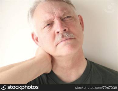 mature man with soreness in his neck