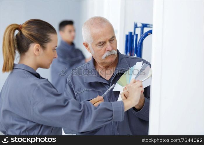 mature man with younger woman holding color swatch