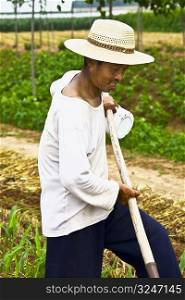 Mature man working in a field, Zhigou, Shandong Province, China